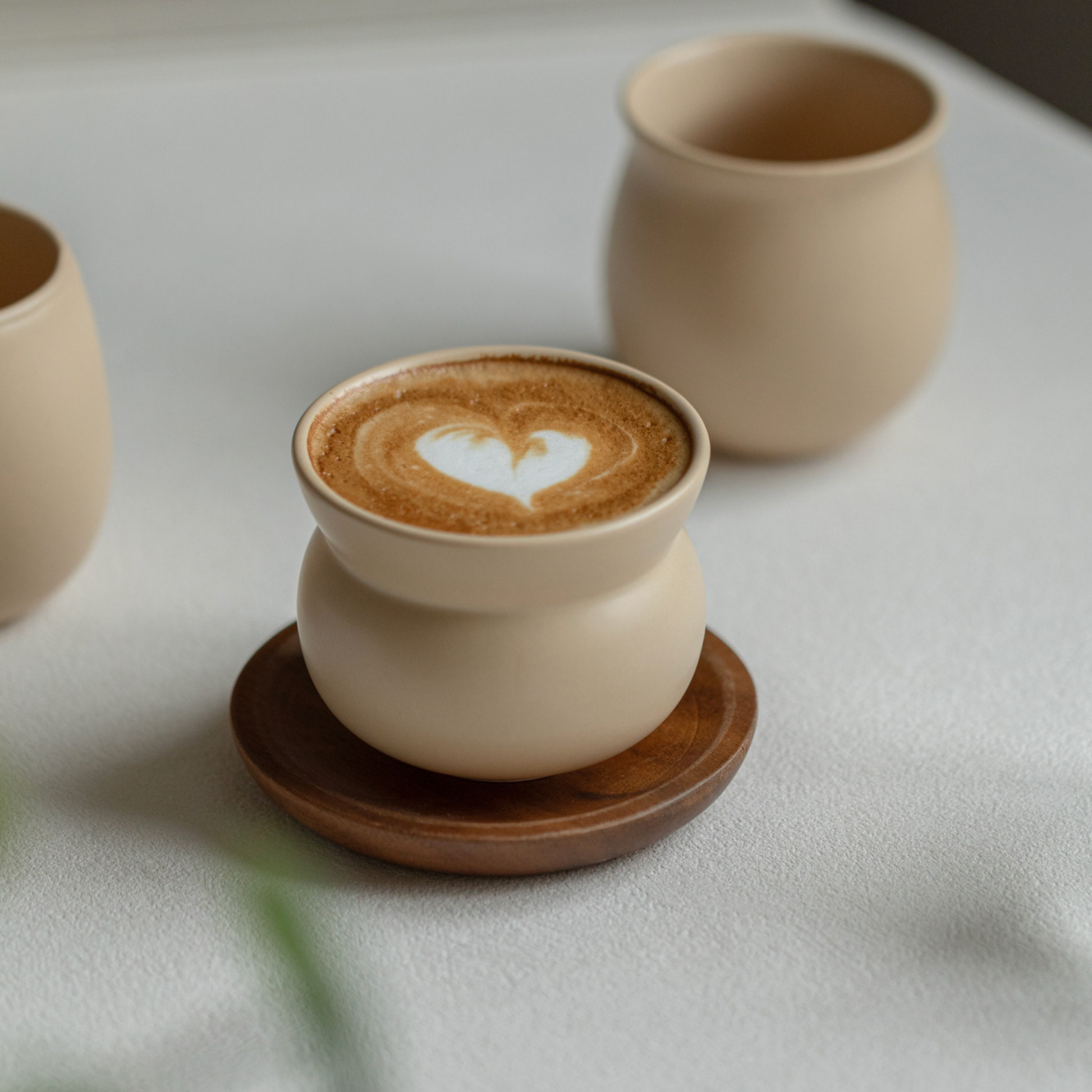 Minimalist cappuccino coffee cups on coffee bar, stoneware cups designed for mindful coffee rituals and everyday home barista use