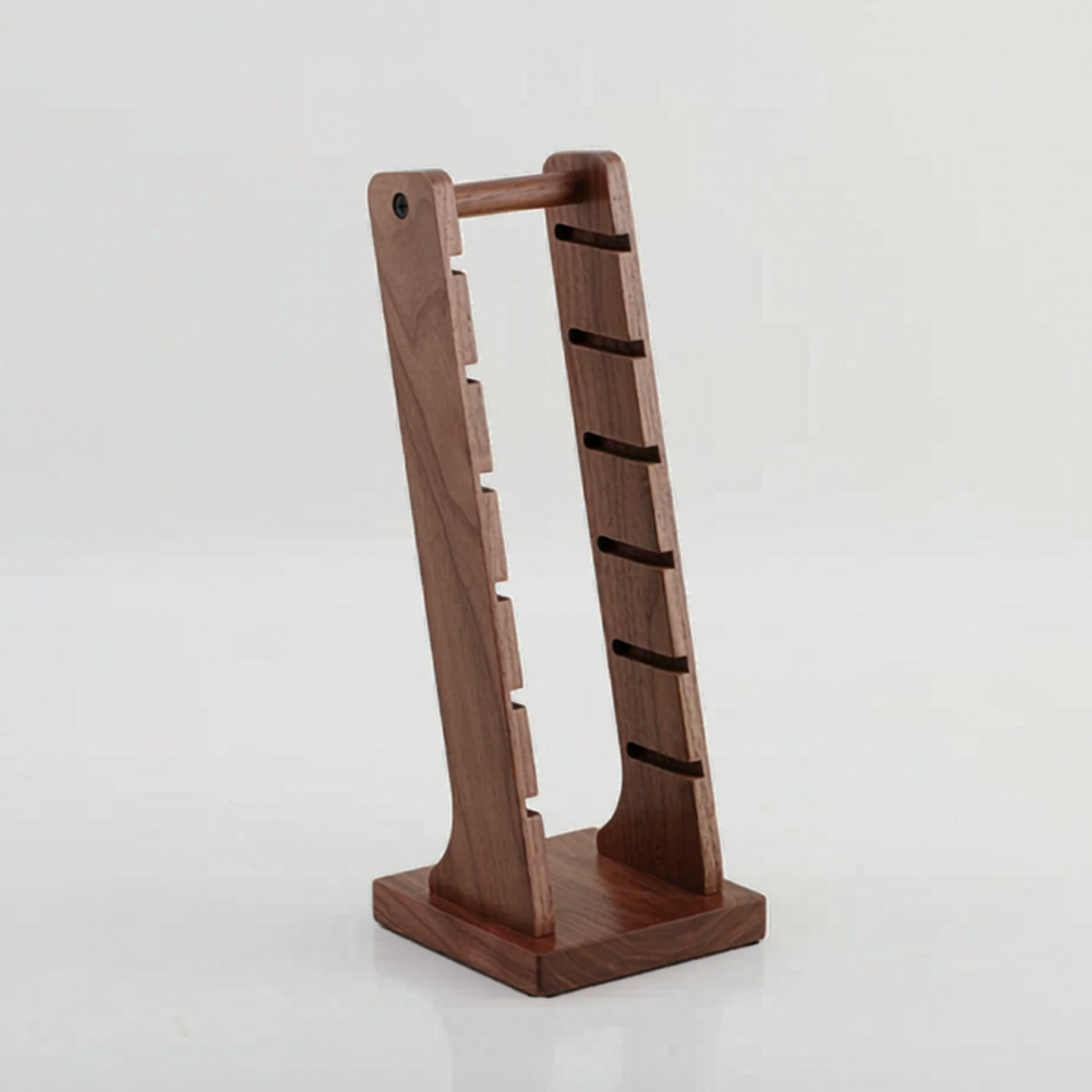 Multi-slot black walnut stand for espresso filter baskets, keeping coffee station tidy.